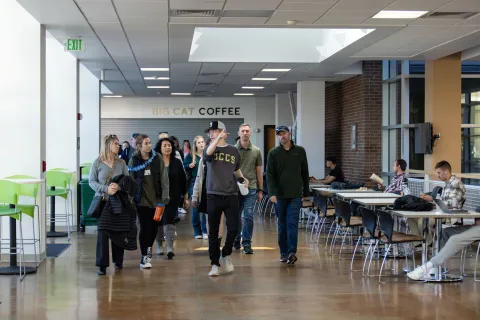 Photo of a group of students and families taking a campus tour through the University Center.